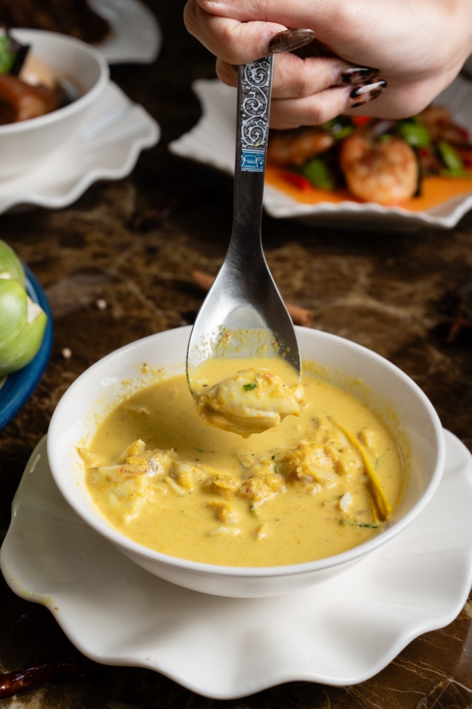 Restaurant food photo of a curry soup dish captured in a clean, editorial style