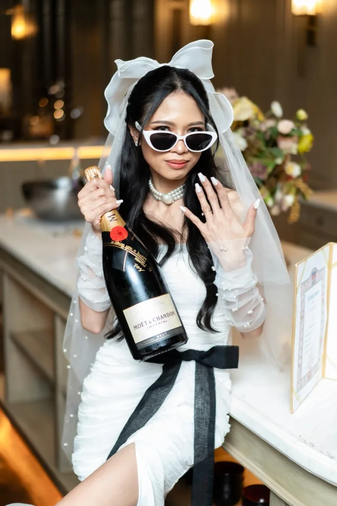 Wedding event photo of a bride celebrating with champagne in an editorial style